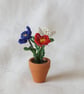 Red, White and Blue Miniature Flowers in a Pot - Image 1