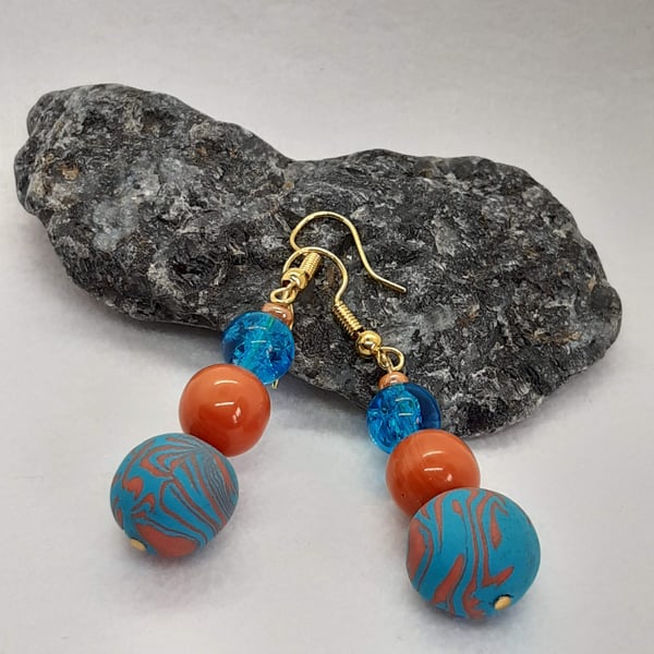 Turquoise and orange dangly earrings