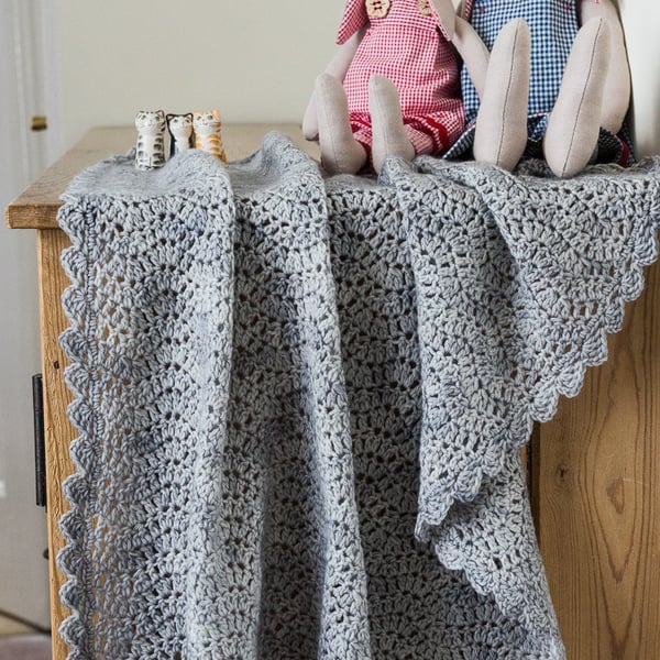 Small crocheted baby blanket made with a merino and cashmere