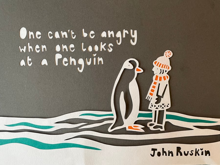 Handmade framed papercut of a penguin and child