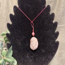 Beautiful wire wrapped grey pebble pendant on adjustable pink cord.  