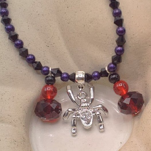 Sparkly Spider Pendant on a Purple and Black Necklace with Red & Black Charms