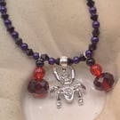 Sparkly Spider Pendant on a Purple and Black Necklace with Red & Black Charms