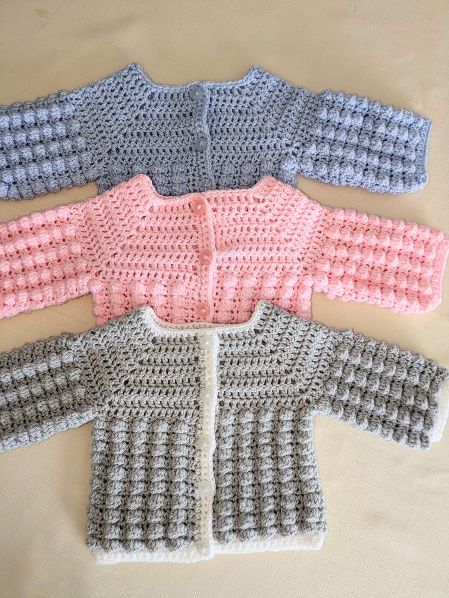 Newborn cardigans or jackets in three different colours 