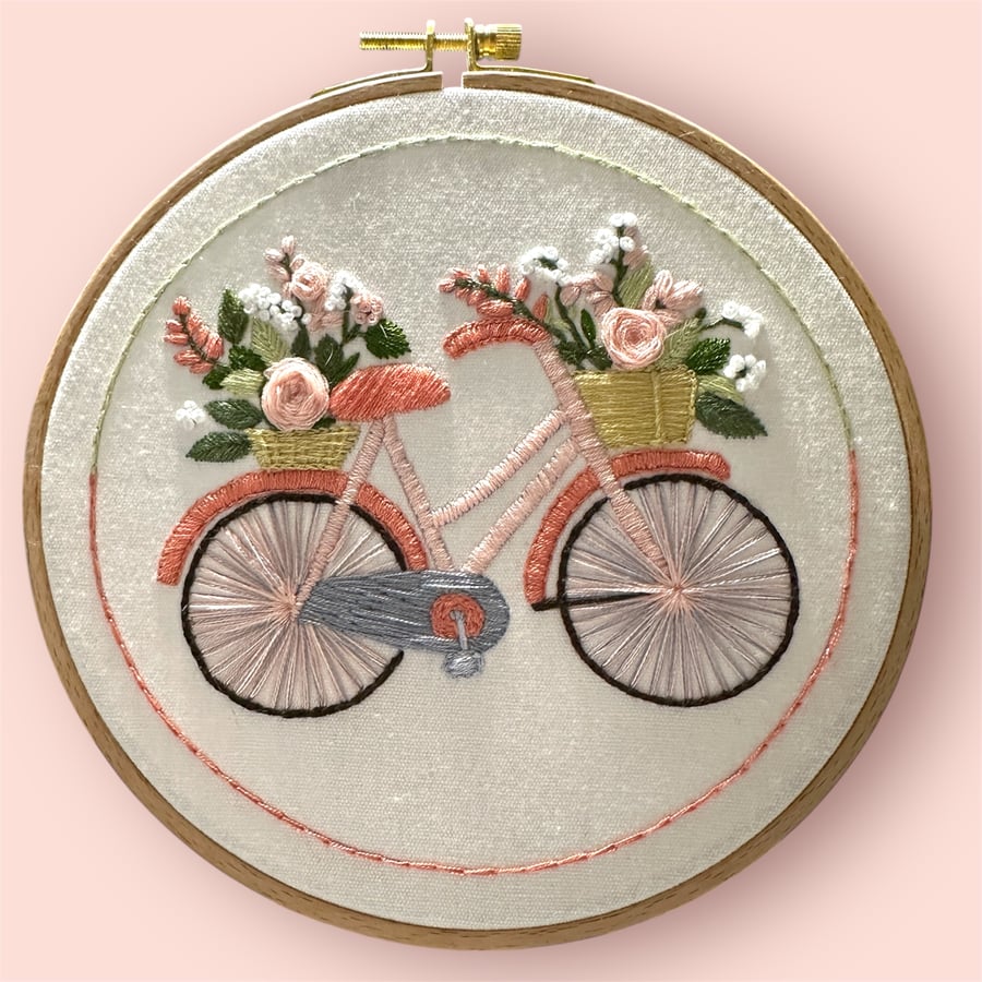 Hand embroidered traditional bicycle with baskets overflowing with flowers 