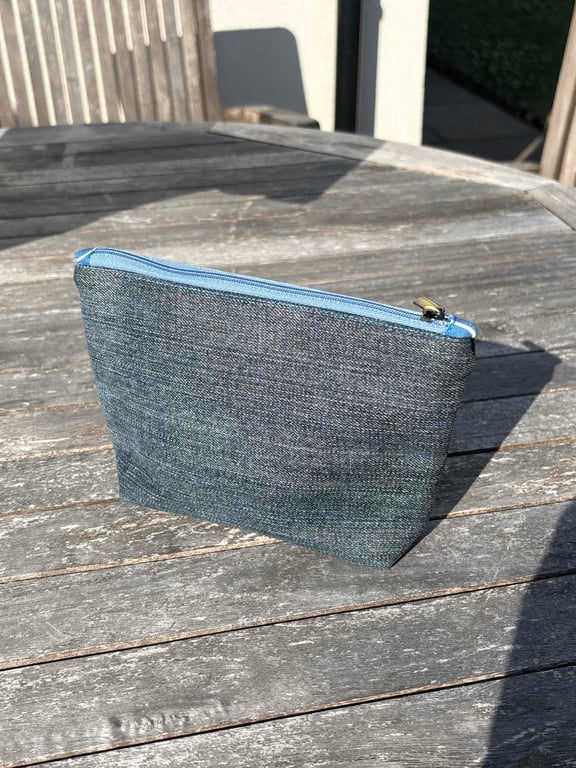 Denim zip top purse with blue squiggle lining