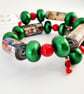 Vibrant memory wire bracelet made with Christmas paper  and preloved beads - Image 3