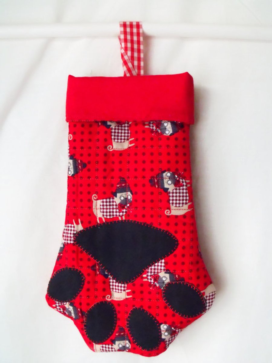 hanging paw shaped christmas stocking for small toys or treats, red lining