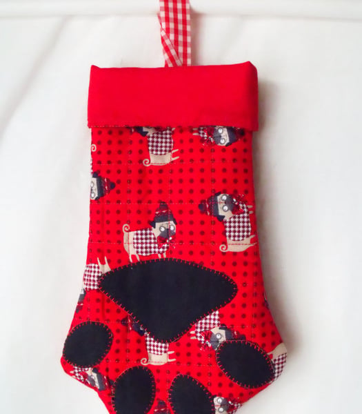 hanging paw shaped christmas stocking for small toys or treats, red lining