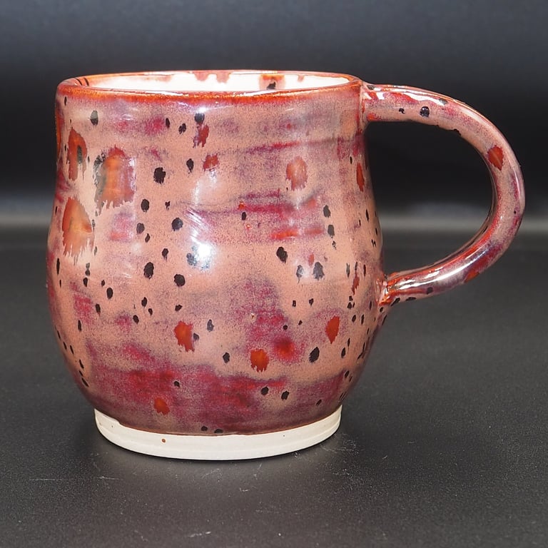 Large stoneware pottery mug finished in multi-coloured plum and white glaze.