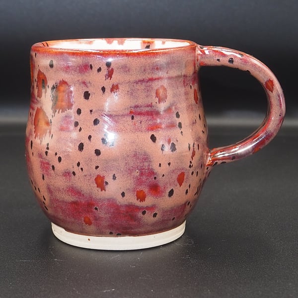 Large stoneware pottery mug finished in multi-coloured plum and white glaze.