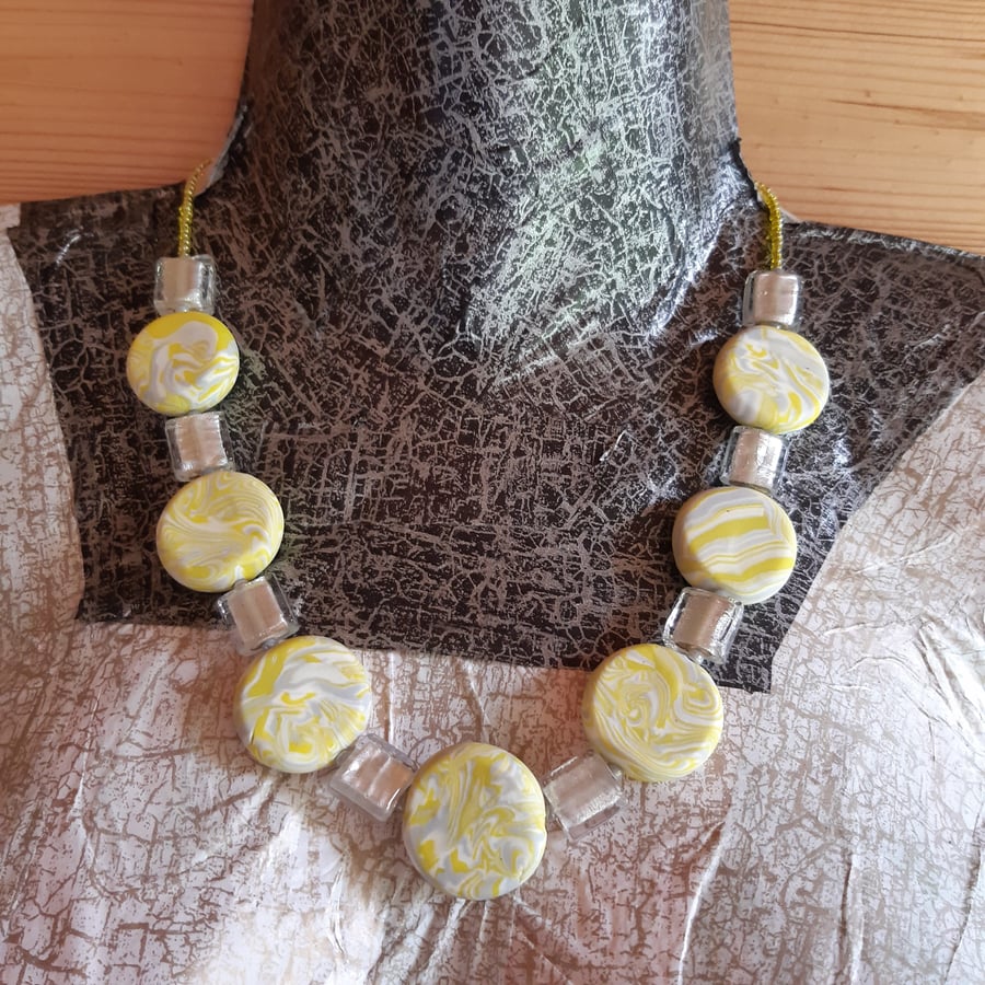 Disc shaped bead and glass necklace