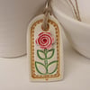 Small ceramic gift tag decoration with flower