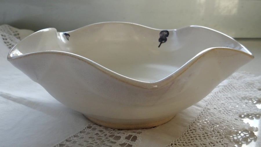 White bowl with scalloped rim and blue flower images - handmade pottery