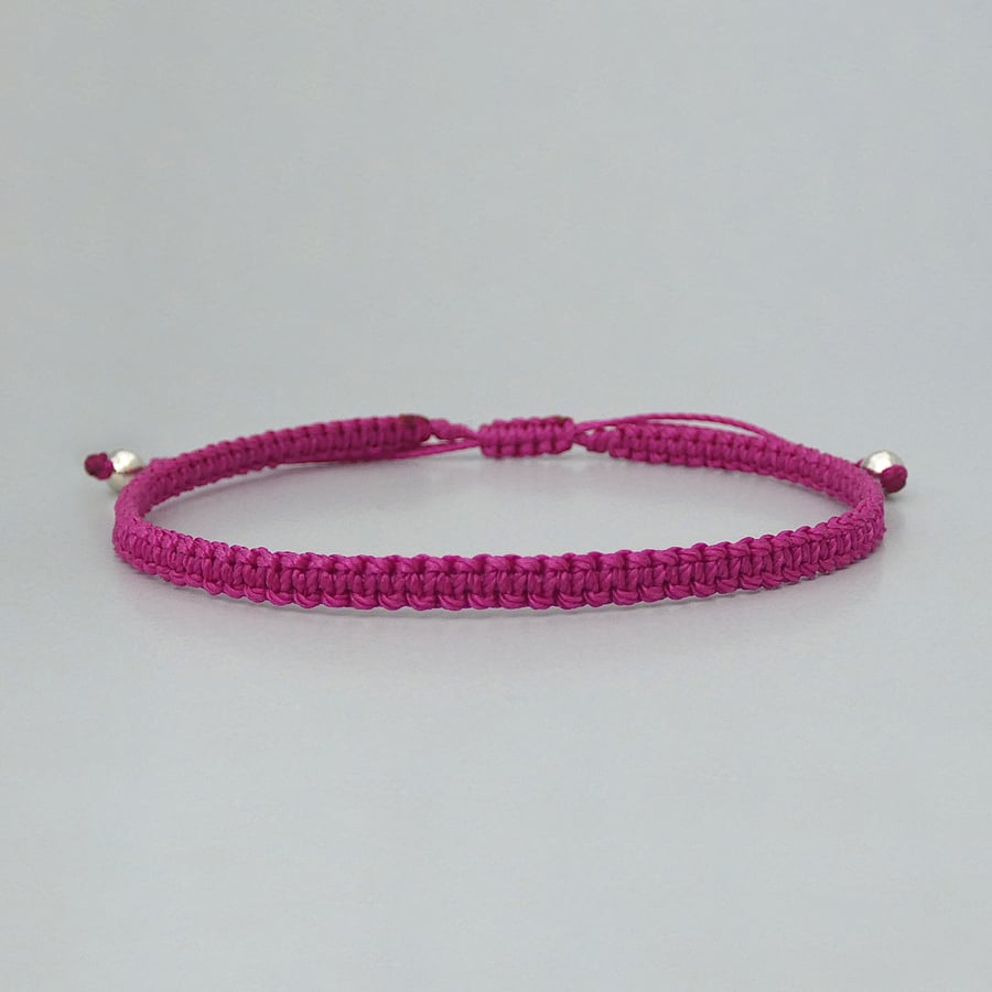 Purple macramé bracelet with silver plated bead ends. Extends from 7” to 9.5