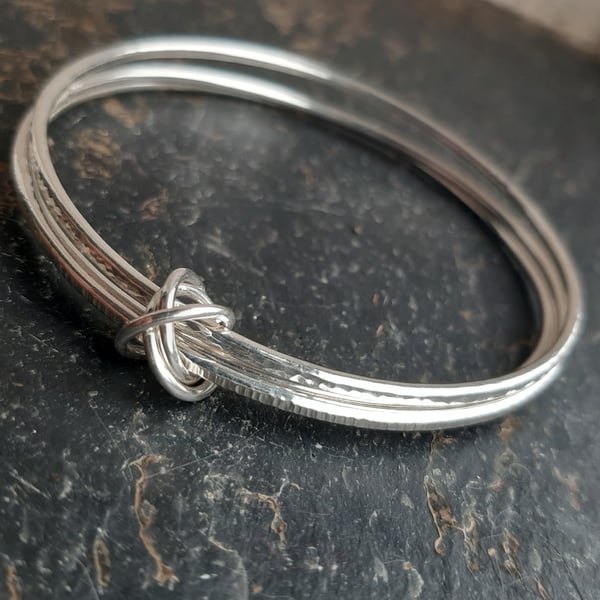Sterling silver trio of bangles joined by linked circles