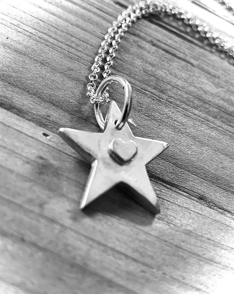 Recycled sterling silver artisan star pendant with an embossed heart