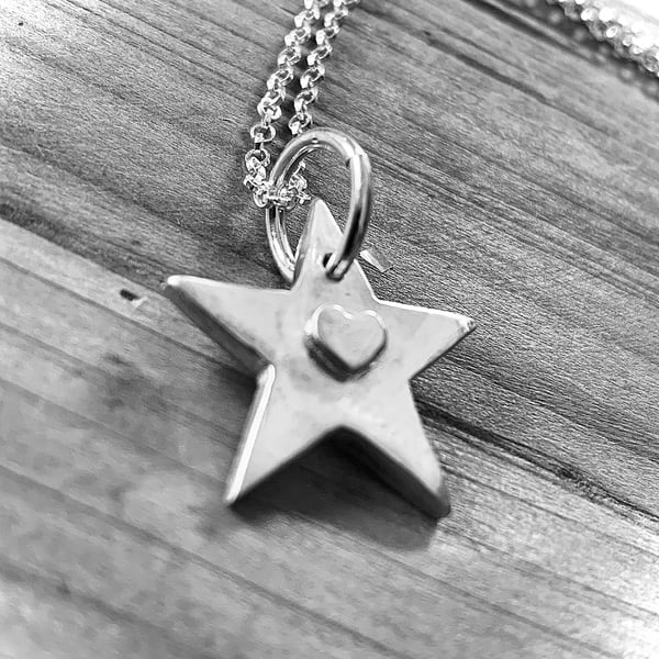 Recycled sterling silver artisan star pendant with an embossed heart