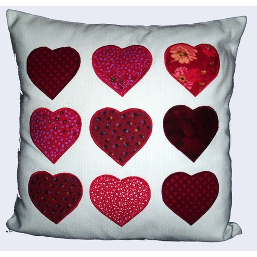 Applique cushion with red hearts