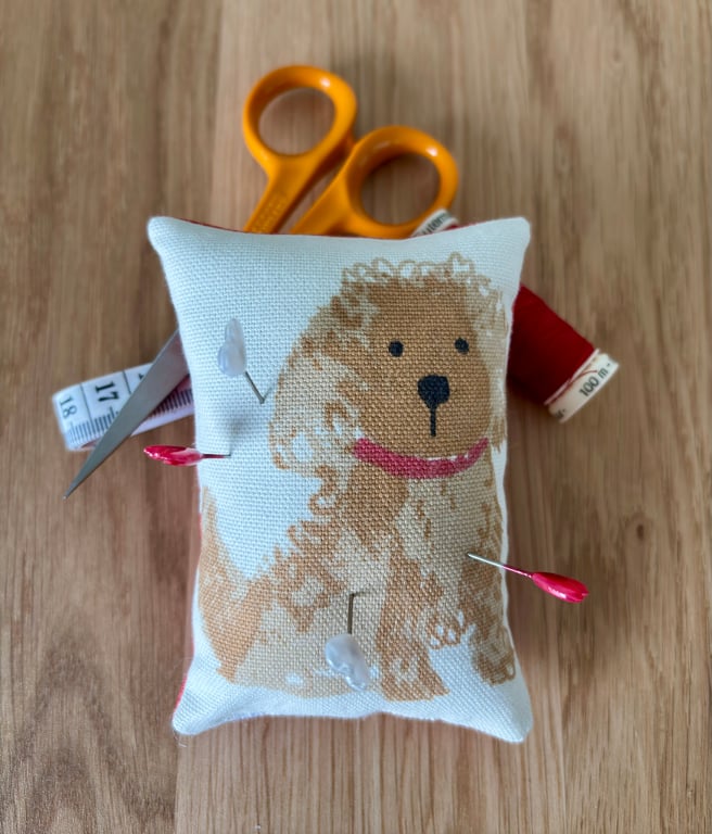Cute “cockapoo type” pincushion with red patterned back
