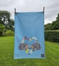 Hedgehogs in primroses heart tea towel design, organic cotton, hanging loop - Image 1