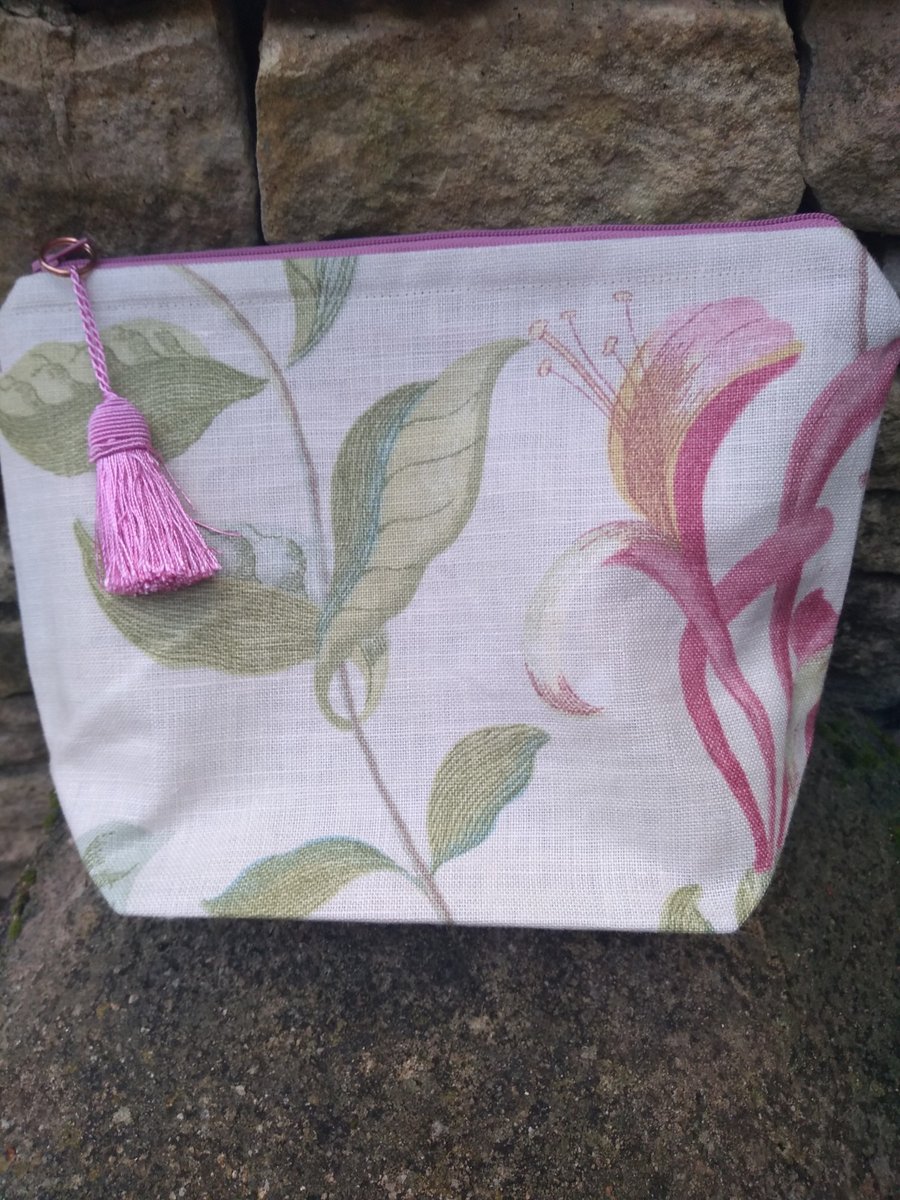 A small Designer Label Fabric Cosmetic or Make-up Bag