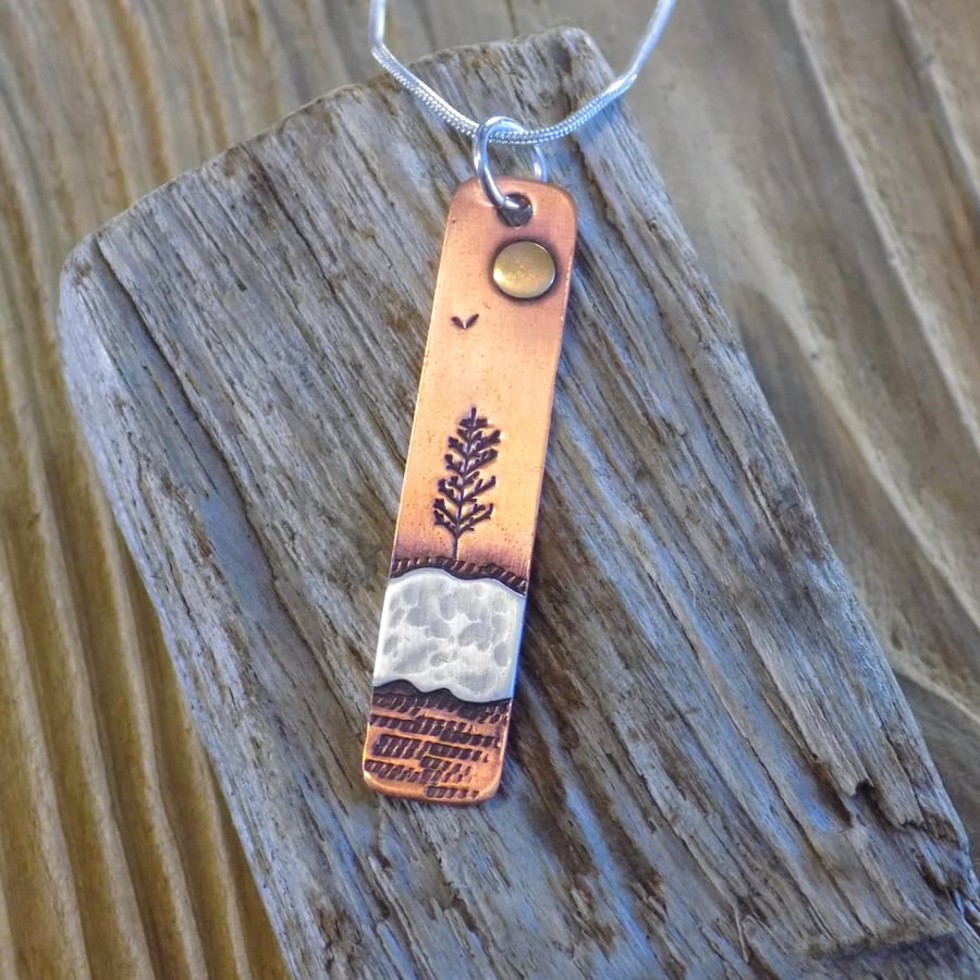 Copper and silver winter sun oblong pendant 