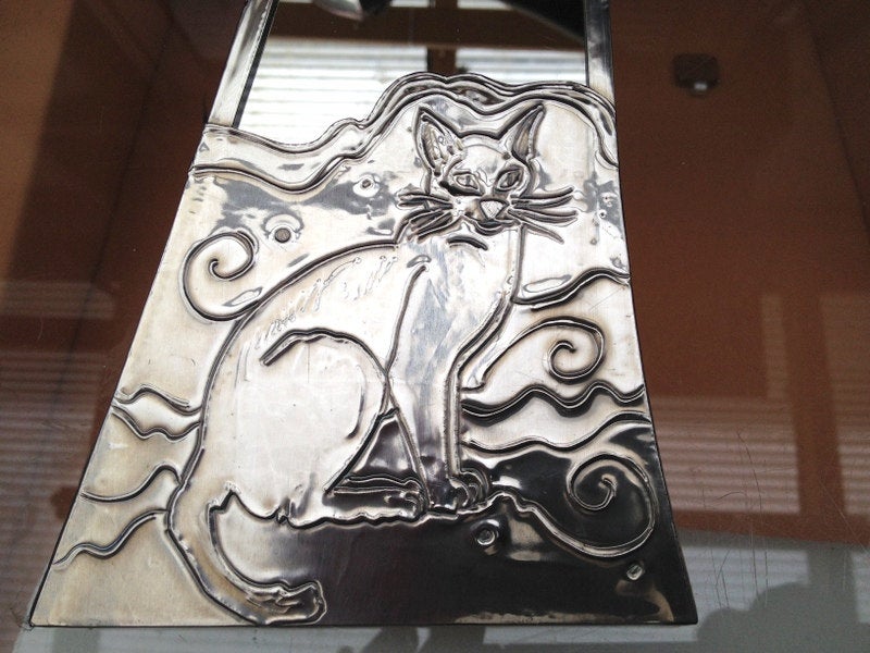 Mirror featuring a Siamese cat.