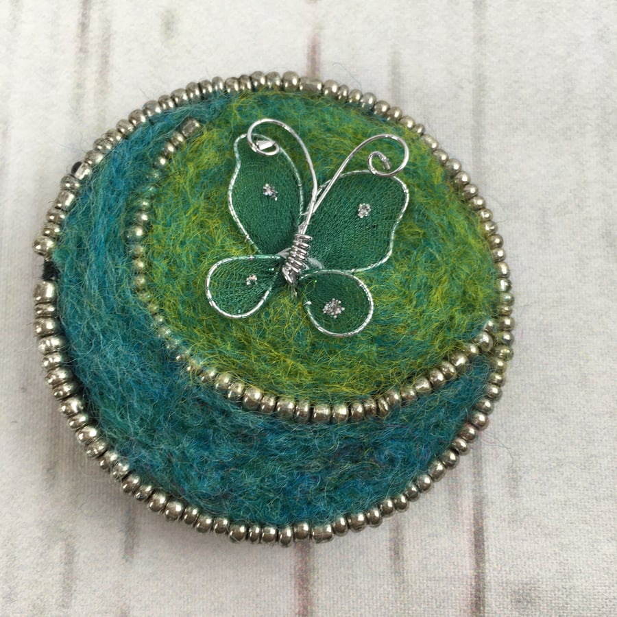 Butterfly brooch, needle felted in green and blue with silver beading