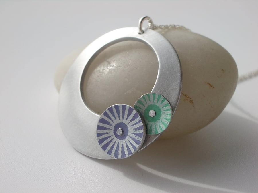 Circle pendant necklace in brushed aluminium with purple and green discs
