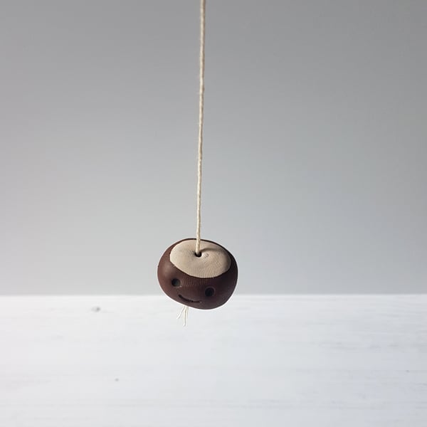 Mini kawaii conker on a string ornament, decoration, autumn, rustic
