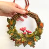 Wet felted and embroidered Autumnal leaves wreath with needle felted mushrooms. 