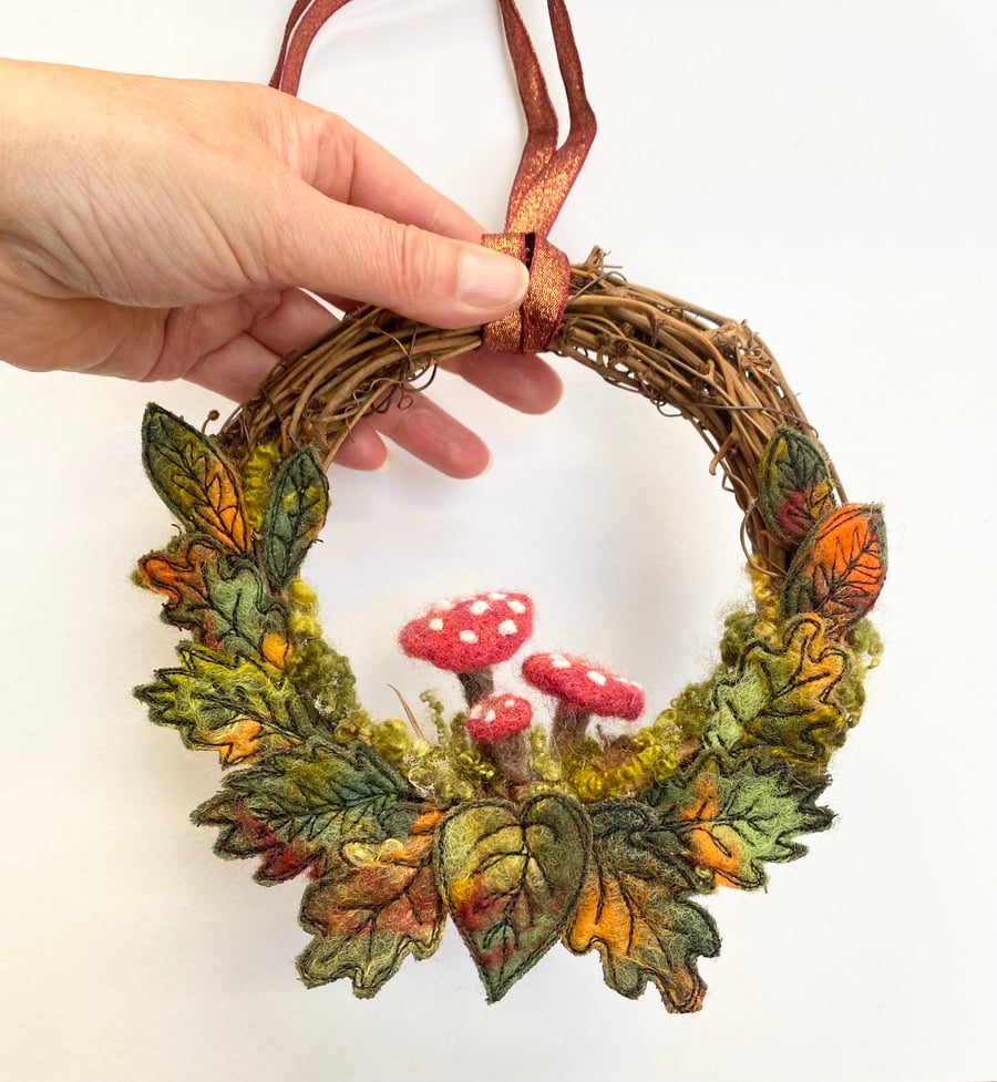 Wet felted and embroidered Autumnal leaves wreath with needle felted mushrooms. 
