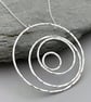 Large round silver statement necklace handmade from hammered silver circles.