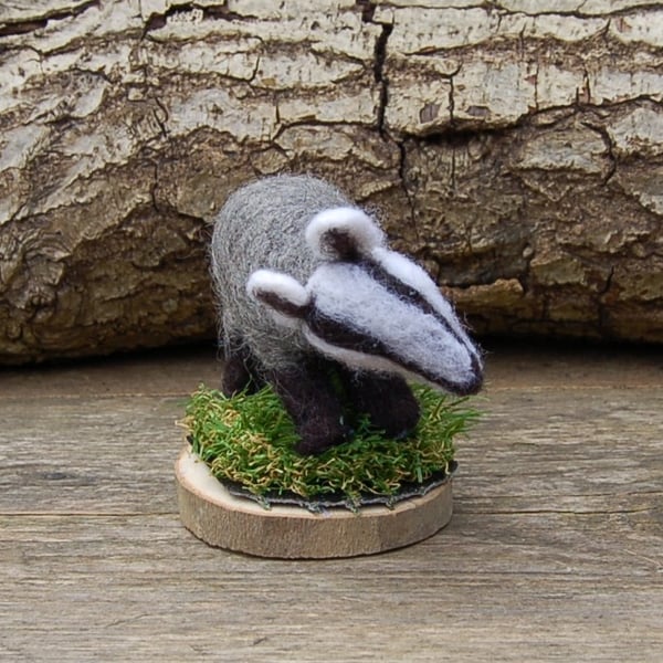 Needle felt Badger mounted on a wood slice with reusued artificial grass
