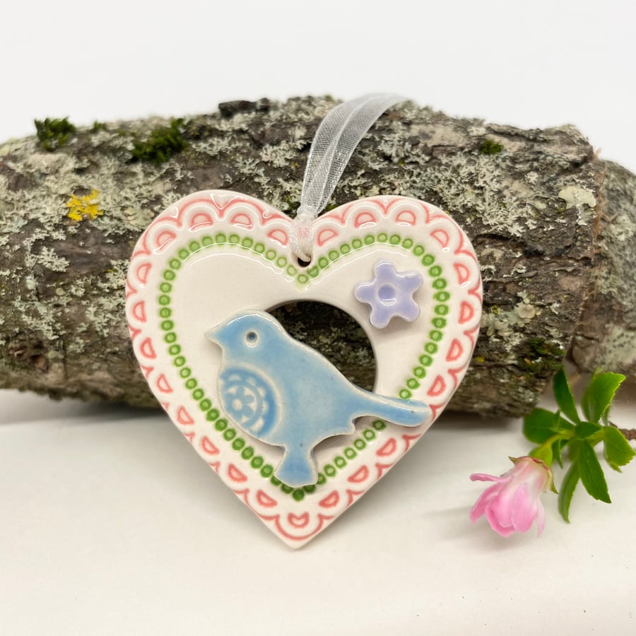 Small Ceramic bird in a pink heart decoration 