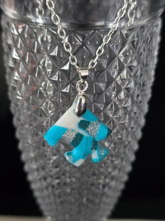 Polymer clay jigsaw peice necklace on a silver plated chain