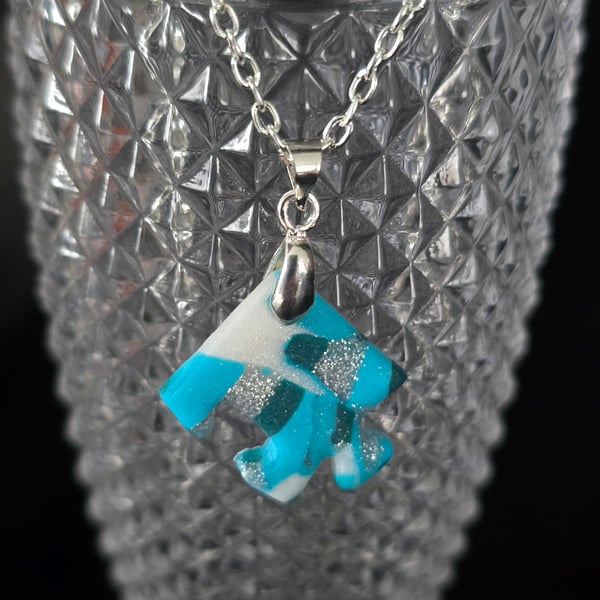 Polymer clay jigsaw peice necklace on a silver plated chain