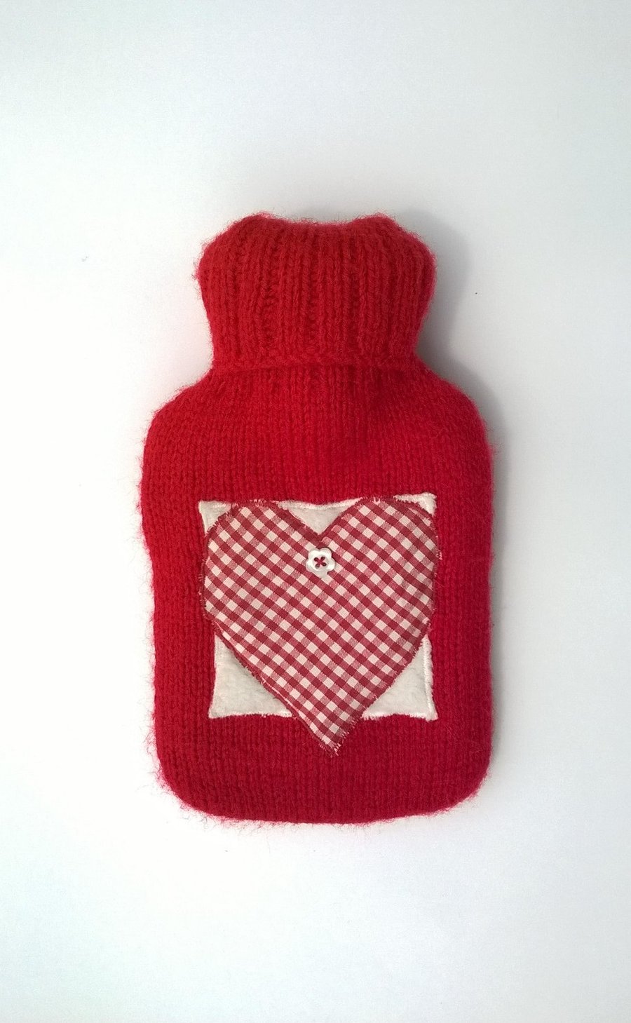 Knitted red hot water bottle with gingham heart