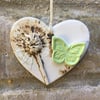 Pottery heart decoration with natural flower design and butterfly
