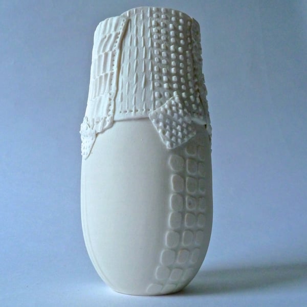 Delicate porcelain vase with resist and impressed decoration.