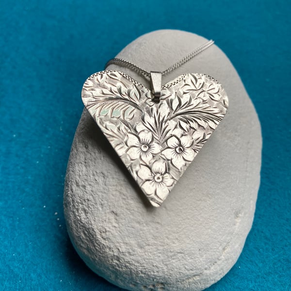 Silver heart shaped floral necklace made from a 1915 cigarette case