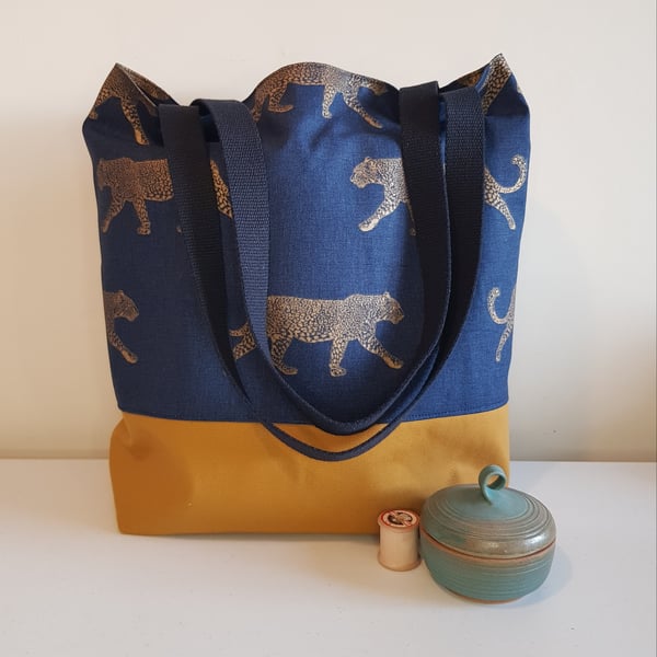 Large tote bag: leopards on navy with ochre canvas base. 