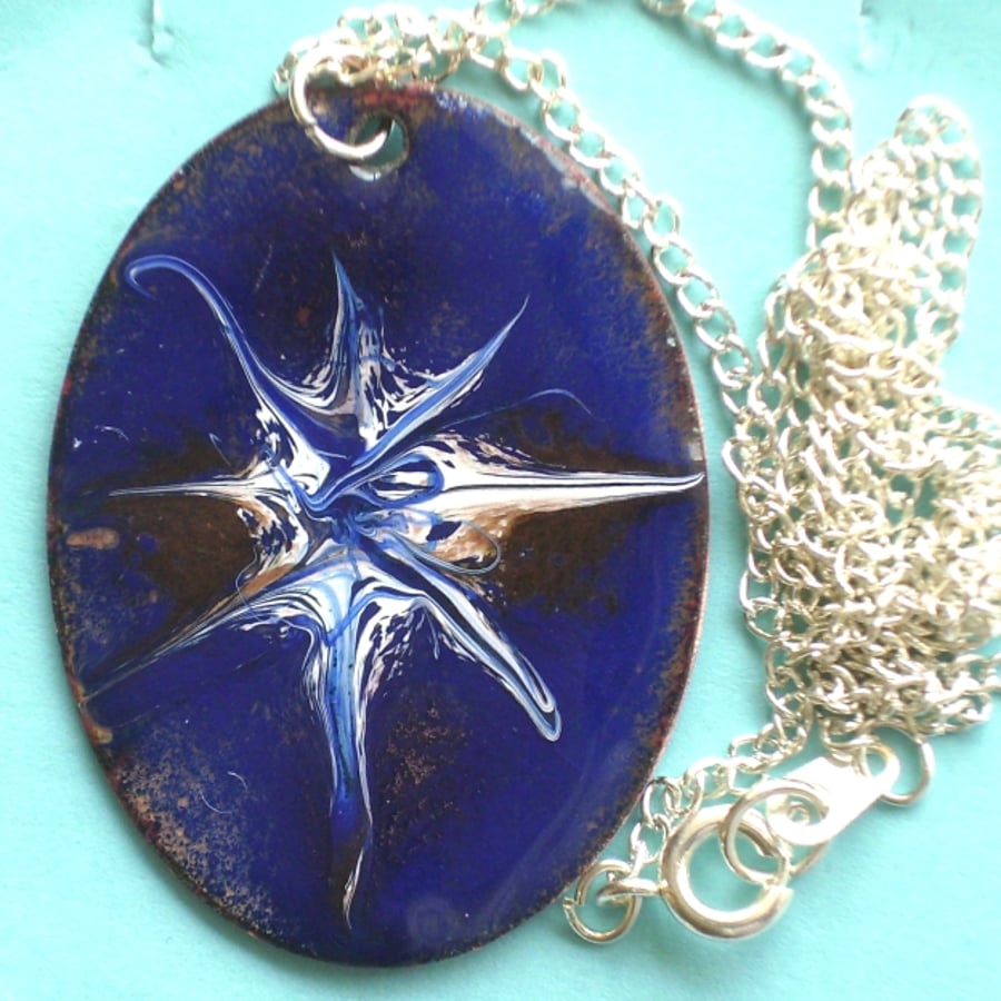oval pendant - white and mauve starburst scrolled on blue