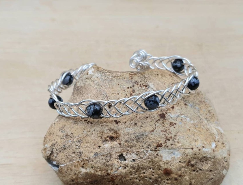 Adjustable Snowflake Obsidian cuff bracelet. Wire wrapped Celtic Weave