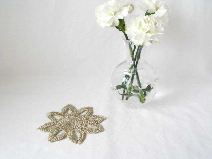 silver coloured delicate crocheted floral embellishment to add to a project