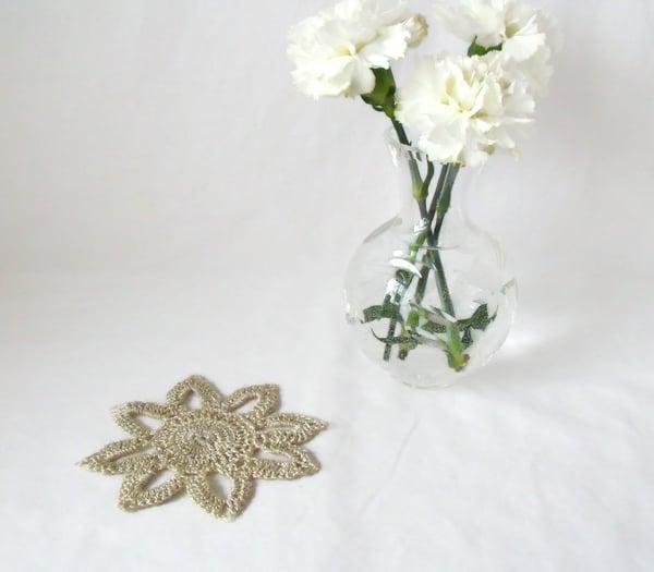 silver coloured delicate crocheted floral embellishment to add to a project