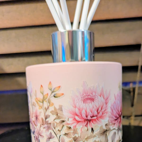 Pink glass floral diffuser bottle with white reed sticks 