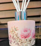 Pink glass floral diffuser bottle with white reed sticks 