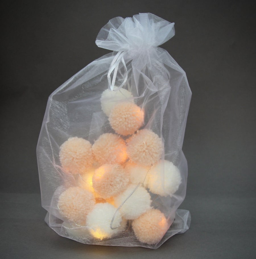 20 pom-pom fairy lights in peaches & cream.